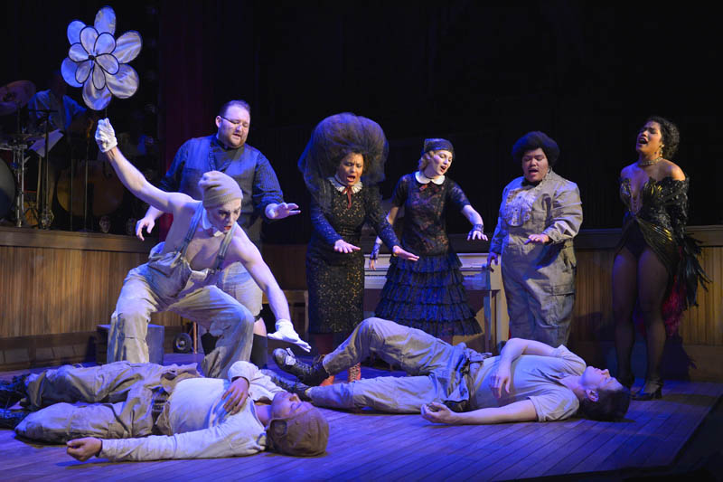 (L-R standing): Koko (Eddie Lopez), Preacher (Arthur Wise), Madame (Danielle Herbert), Roxy (Lauren Hart), Handsome Carl (Amy Lizardo), and Rae (Taylor Iman Jones) mourn the deaths of CJ (left, Christopher Livingston) and Coughlin (Jon Beavers) in The Unfortunates, playing at A.C.T.’s Strand Theater through Sunday, April 10. Photo by Kevin Berne.